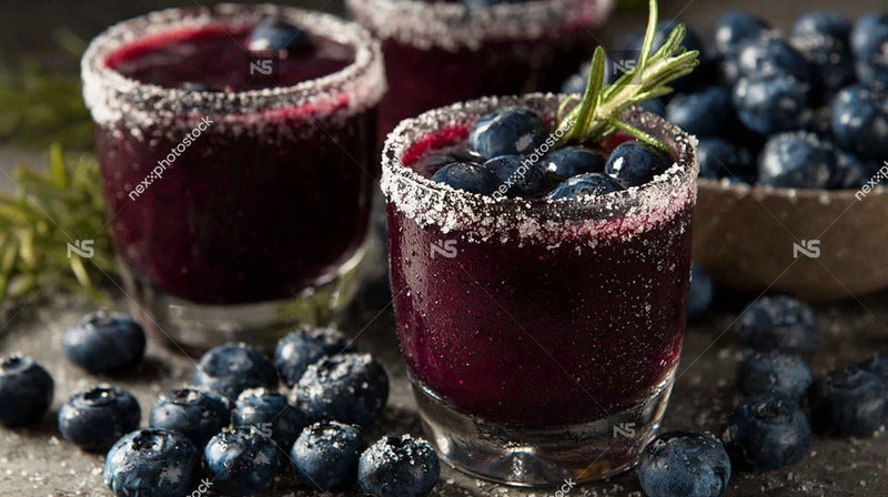 Blueberry Margaritas With Salted Rims Garnished With Blueberries And A Sprig Of Rosemary Served In Glasses On A Table — Stock Photo