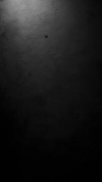 Black And White Photograph Of A Dark Hallway With A Single Light Source At The End — Stock Photo