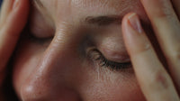 A Close Up Portrait Of An Individual With Their Hand Placed On Their Forehead In A Pose — Stock Photo