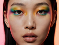 A Portrait Of A Person Wearing Vibrant Makeup With Colorful Eyeshadow And Bold Eyeliner — Stock Photo