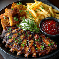 Close Up Of A Plate Of Grilled Chicken And Fries With Dipping Sauce Garnished With Parsley And Served On A Black Plate — Stock Photo