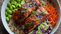 A Plate Of Grilled Salmon Served Over A Bed Of Rice And Vegetables Including Carrots And Broccoli Garnished With Sesame Seeds — Stock Photo