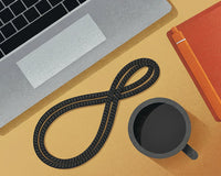 A Digital Illustration Of A Workspace With A Coiled Black Cable And A Coffee Cup On A Wooden Table — Stock Illustration