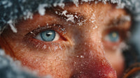 Woman With Snowflakes On Her Face Looking Out From Behind A Window In A Snowstorm — Stock Photo