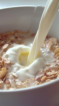 milk pouring into bowl of cereal - Stock Video
