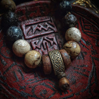 Antique Beaded Bracelet With Celtic Knot Design A Variety Of Stones And Metals Displayed On A Red Tray — Stock Photo