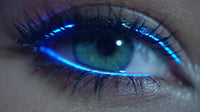 glowing blue eye makeup with a close up view of an eye showcasing the vibrant color and glowing effect against a dark background - Stock Video