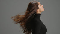 A Woman With Long Hair Is Captured In A Portrait Style Image Showcasing Her Flowing Locks Against A Neutral Background — Stock Photo