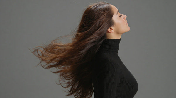 A Woman With Long Hair Is Captured In A Portrait Style Image Showcasing Her Flowing Locks Against A Neutral Background — Stock Photo