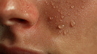 A Close Up Photograph Focusing On A Person S Face With Visible Droplets Of Water Dew On It — Stock Photo