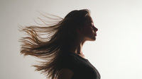 A Woman With Long Hair Captured In Motion Creating A Dynamic And Portrait Against A White Background — Stock Photo