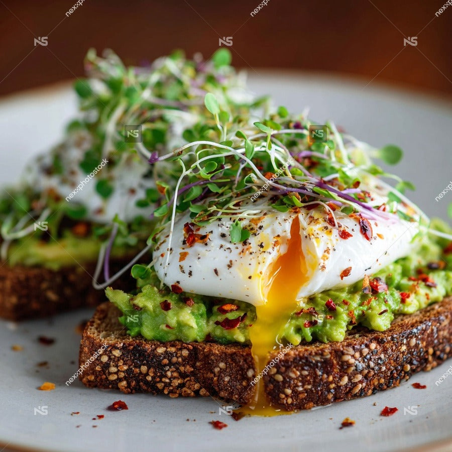A Plate Of Avocado Toast Topped With A Fried Egg Garnished With Microgreens And A Sprinkle Of Red Pepper Flakes — Stock Photo