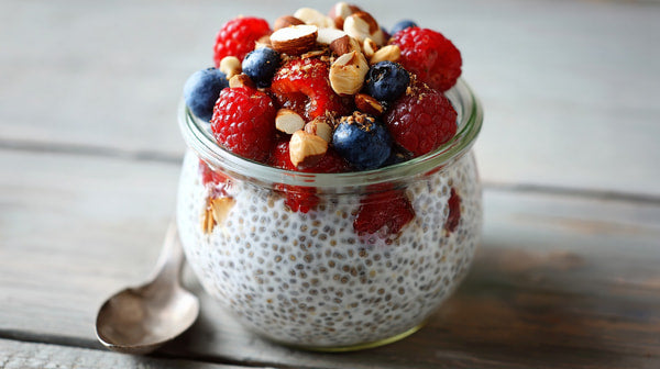 A Jar Of Raspberry Chia Pudding With Berries And Nuts On Top Placed On A Wooden Surface — Stock Photo