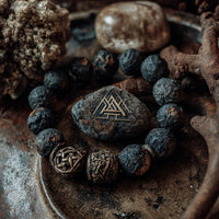 Rustic Charm Bracelet With Amber Stone And Trinity Knot Pendant On A Table With Other Rustic Items — Stock Photo