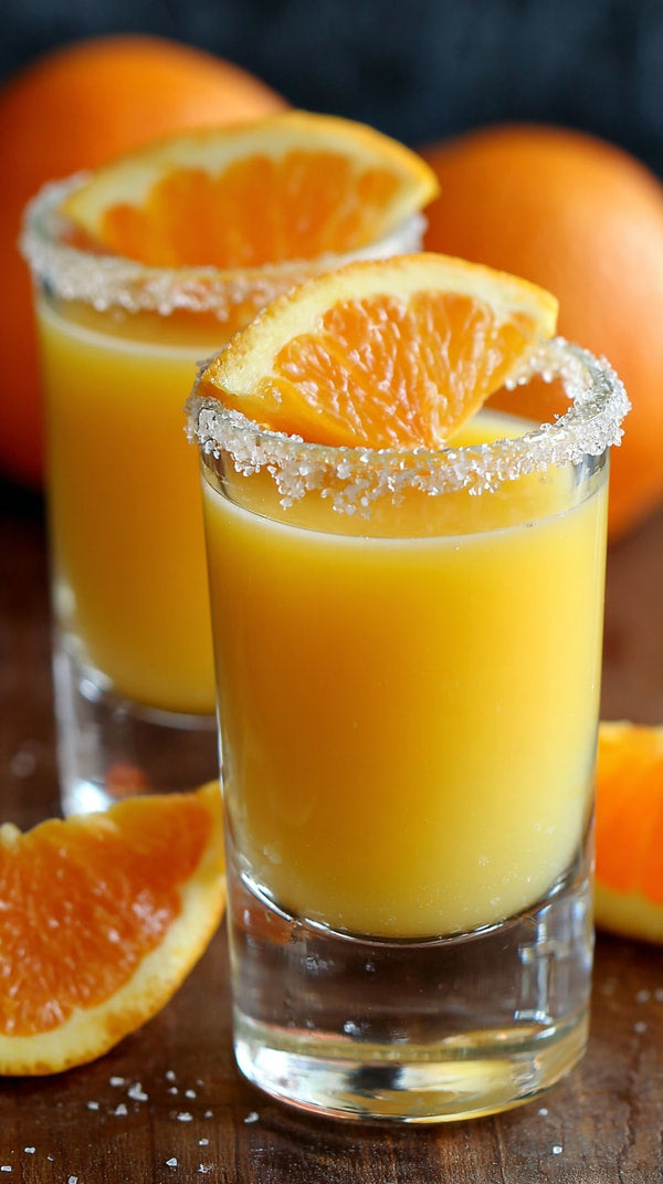 Fresh Orange Margarita Shots Garnished With Salt And Sliced Oranges Displayed On A Wooden Surface — Stock Photo