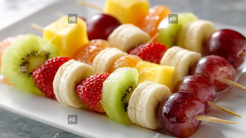 A Plate Of Assorted Fruit Skewers Including Bananas Strawberries And Grapes Arranged In An Appealing Manner For Presentation — Stock Photo