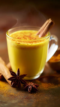 a glass of cinnamon spiced drink garnished with a cinnamon stick placed on a table - Stock Video