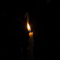 A Single Lit Candle Against A Black Background — Stock Photo