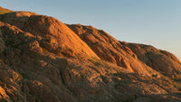 rocky mountain sunset with red rock formations and clear sky - Stock Video