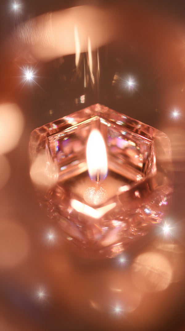 A Cube Shaped Candle With Vibrant Colors Illuminated From Within Set Against A Blurred Background Of Sparkling Lights — Stock Photo