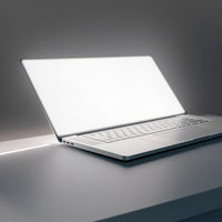 A Silver Laptop Computer Is Prominently Displayed On A Table With Its Screen Facing Towards The Viewer — Stock Photo