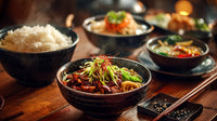 asian cuisine buffet with various bowls of food including noodles and rice dishes displayed on a table - Stock Video