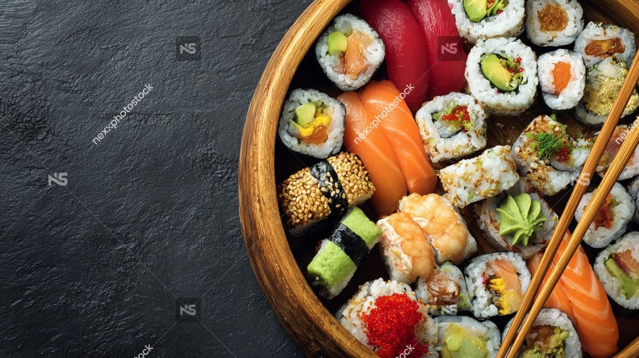 A Wooden Sushi Platter Filled With A Variety Of Sushi Pieces Including Salmon Nigiri And Sashimi Accompanied By Chopsticks — Stock Photo