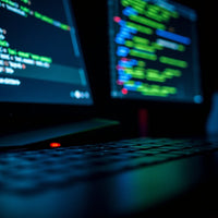 Three Computer Monitors Code With A Laptop Keyboard In Front Of Them — Stock Photo