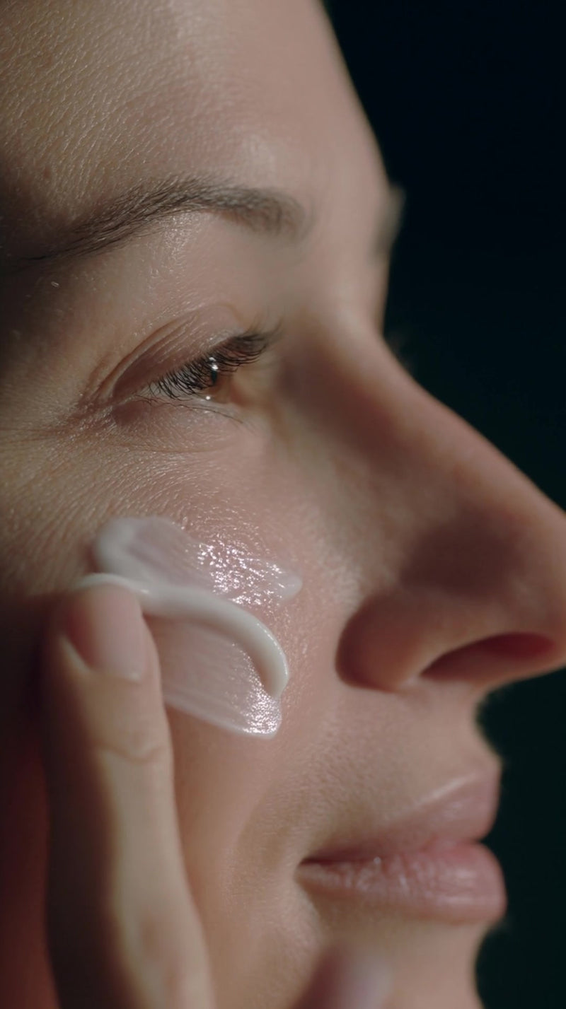 skin care routine captured in a close up shot of a woman applying skincare product to her face - Stock Video