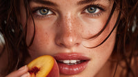 A Young Woman With Blue Eyes And Freckles Captured In A Close Up Portrait Enjoying A Peach — Stock Photo