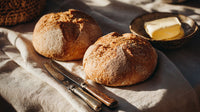 Two Loaves Of Artisan Bread On A Table — Stock Photo