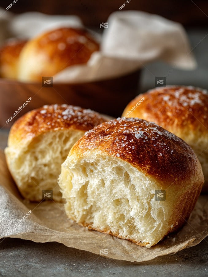Golden Brown Baked Goods Bread Rolls Muffins Displayed On A Wooden Surface With A Parchment Paper Background — Stock Photo