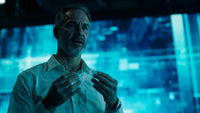 man in white shirt standing in front of blue background with hands clasped together - Stock Video