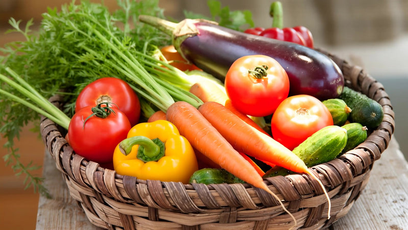 a basket of fresh vegetables including carrots tomatoes and peppers displayed on a table - Stock Video