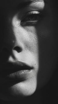 A Black And White Portrait Of A Woman With Her Face Partially Obscured By Shadow Showcasing Her Profile From The Side — Stock Photo
