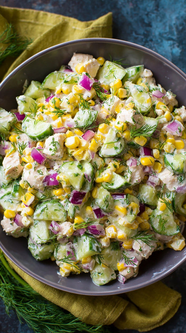 A Large Bowl Of Salad With Chicken And Corn Garnished With Herbs On A Table — Stock Photo