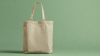 A Beige Canvas Tote Bag With A Simple Design Placed Against A Green Background — Stock Photo