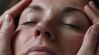 A Close Up Photograph Of A Person S Face With Their Eyes Closed And Hands Gently Placed On Either Side Of Their Head — Stock Photo