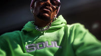 shows a man wearing sunglasses a colorful hoodie with the word soul on it and pink hair - Stock Video