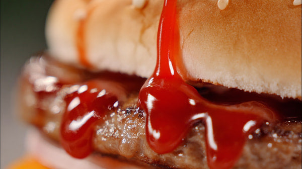 Ketchup Drenched Hamburger With A Close Up View Of Ketchup Dripping From It Showcasing The Condiment S Vibrant Red Color And Its Glossy Texture — Stock Photo
