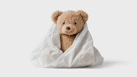 A Teddy Bear Wrapped In A Blanket — Stock Photo