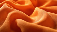 Displays A Close Up View Of An Orange Fabric With A Soft Texture A Piece Of Cloth A Material With A Wavy Pattern — Stock Photo