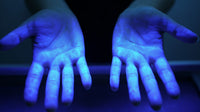 Displays A Pair Of Hands With Blue Glow Against A Dark Background Captured From A Top Down Perspective — Stock Photo
