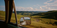 A Car Window View Of A Rural Road Showcasing A Scenic Landscape With Rolling Hills And A Clear Blue Sky — Stock Photo
