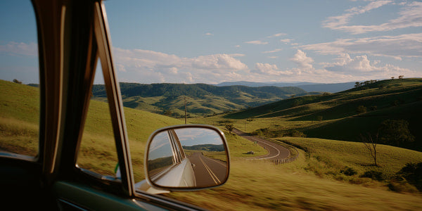 A Car Window View Of A Rural Road Showcasing A Scenic Landscape With Rolling Hills And A Clear Blue Sky — Stock Photo