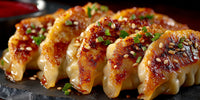 Crispy Fried Dumplings Topped With Sesame Seeds Served On A Black Plate — Stock Photo