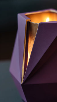 A Purple And Gold Candle Holder With A Lit Candle Inside Set Against A Dark Background — Stock Photo